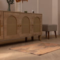 Vintage 2x3 ft Turkish wool and cotton doormat in brown and gray with geometric patterns on a wooden floor.