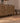 Vintage 2x3 ft Turkish wool and cotton doormat in brown and gray with geometric patterns on a wooden floor.