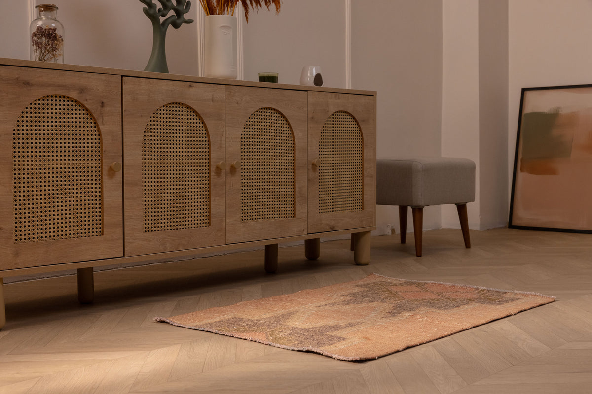 Vintage 2x3 ft Turkish wool and cotton doormat in brown and gray with geometric patterns on a wooden floor.