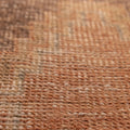 Close-up of a vintage hand-woven wool and cotton Turkish rug with brown and gray geometric patterns.