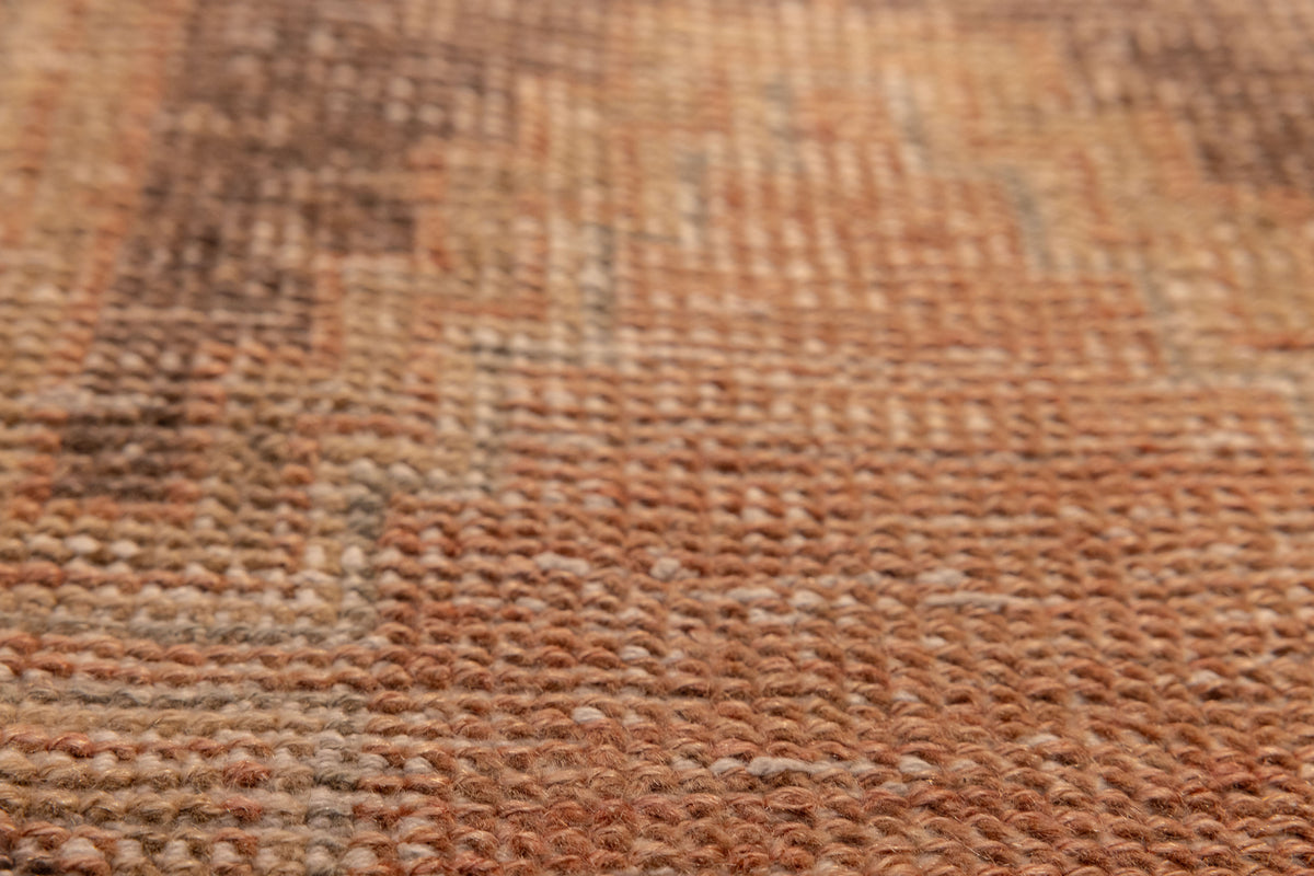 Close-up of a vintage hand-woven wool and cotton Turkish rug with brown and gray geometric patterns.