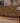 Handmade 2.4 x 11 ft wool and cotton runner rug in rustic brown and orange with geometric Persian-style patterns.