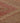 Close-up of a vintage Turkish runner rug with pink and gray geometric patterns in hand-woven wool and cotton.