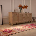 Handmade pink and beige Persian-style wool and cotton runner rug with bohemian floral patterns.