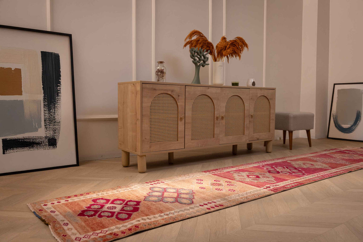 Handmade pink and beige Persian-style wool and cotton runner rug with bohemian floral patterns.