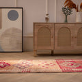 Handmade 2.5x12.6 ft wool and cotton runner rug featuring pink and beige floral patterns in a bohemian Persian style.