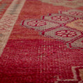 Handmade pink and beige Persian-style wool and cotton runner rug with bohemian floral patterns.