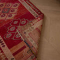 Handmade 2.5 x 12.6 ft wool and cotton runner rug in pink and beige with a bohemian floral Persian-style pattern.