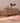 Handmade pink and white Persian-style wool and cotton runner rug with geometric patterns on a wooden floor.