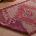Handmade pink and white wool-cotton runner rug with geometric Bohemian patterns, 2.8 x 9.7 ft, shown on a wooden floor.