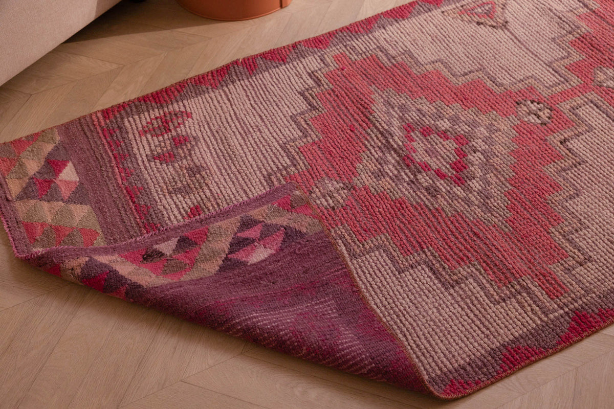 Handmade pink and white wool-cotton runner rug with geometric Bohemian patterns, 2.8 x 9.7 ft, shown on a wooden floor.