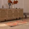 Vintage Malatya Turkish runner rug in orange and brown with geometric patterns on a wooden floor.