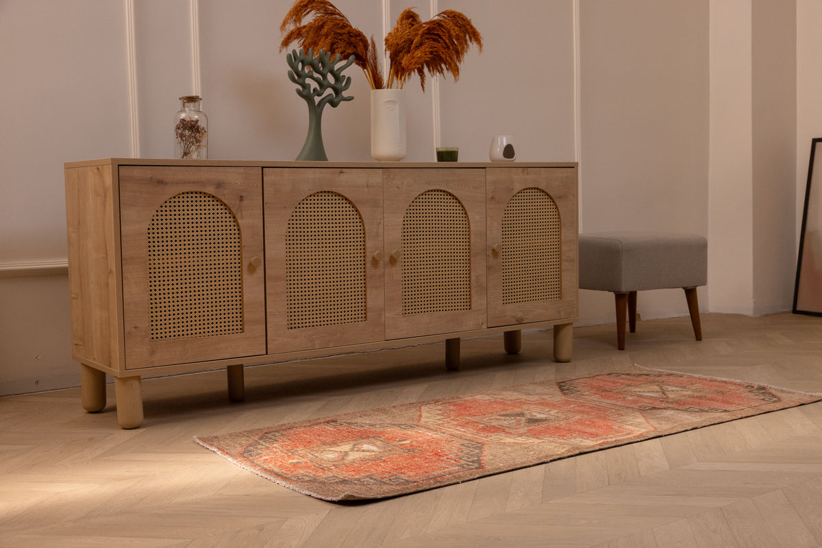 Vintage Malatya Turkish runner rug in orange and brown with geometric patterns on a wooden floor.