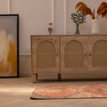 Vintage Malatya Turkish runner rug in burnt orange and brown wool with geometric patterns on a wooden floor.