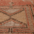Hand-woven vintage Turkish runner rug in burnt orange and brown with rustic geometric wool and cotton patterns.