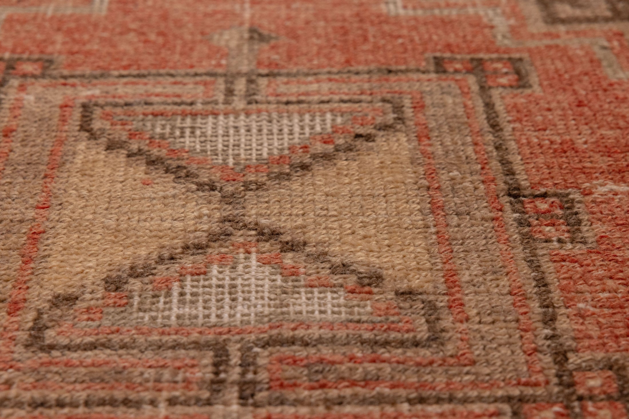 Hand-woven vintage Turkish runner rug in burnt orange and brown with rustic geometric wool and cotton patterns.