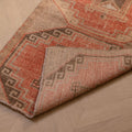 Vintage Malatya Turkish runner rug in orange and brown with geometric patterns, hand-woven from wool and cotton.