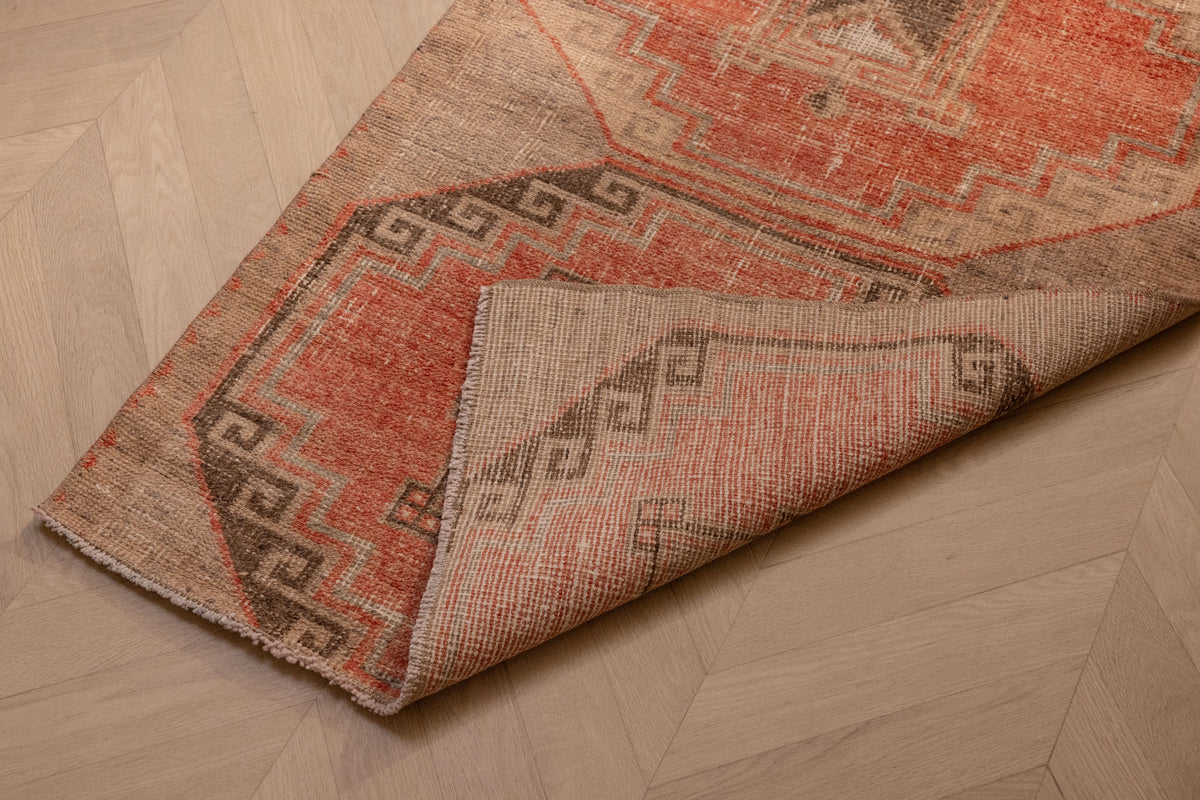 Vintage Malatya Turkish runner rug in orange and brown with geometric patterns, hand-woven from wool and cotton.