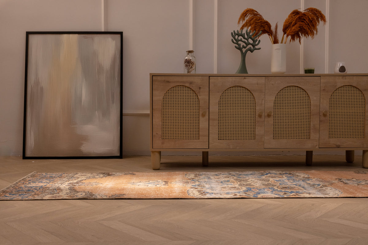 Vintage Isparta Turkish runner rug in orange and blue floral wool, 2.6x10 ft, displayed in a bohemian interior.