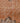 Close-up of a vintage hand-woven Isparta runner rug featuring burnt-orange wool and cotton with soft floral motifs.