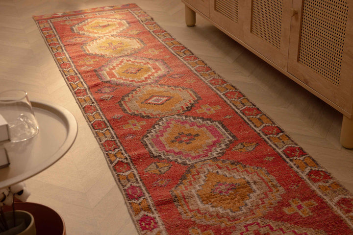 Handmade 2.5x10.5 ft Turkish runner rug in red and brown wool-cotton blend with bohemian geometric patterns.