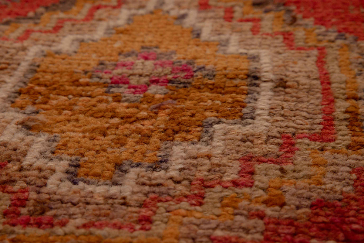 Handmade Turkish runner rug in red and brown with a low-pile wool and cotton blend and intricate geometric bohemian patterns.