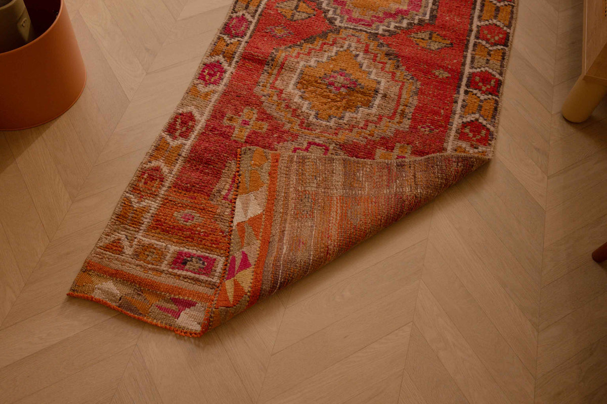 Handmade 2.5x10.5 ft Turkish runner rug in red and brown wool-cotton blend with geometric bohemian patterns.