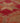 Close-up of a handmade wool and cotton runner rug featuring a brown and pink floral, maximalist Persian-style pattern.