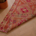 Handmade 2.7x12.6 ft wool and cotton Persian-style runner in brown and pink with a maximalist floral bohemian pattern.