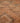 Close-up of a low-pile, handmade orange and grey wool-cotton blend runner rug with a geometric bohemian pattern.