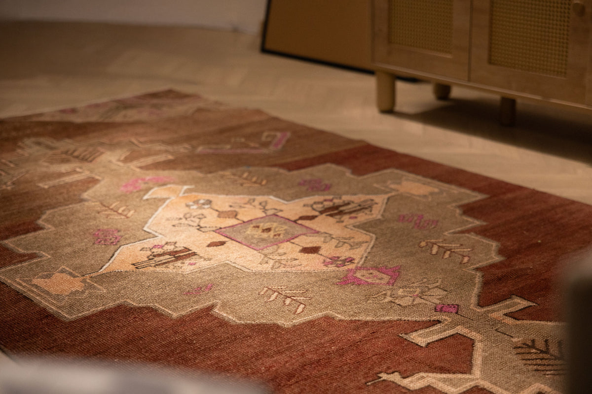 Hand-woven vintage Kars Turkish area rug in brown with geometric patterns, crafted from wool and cotton in a 5x9 ft size.