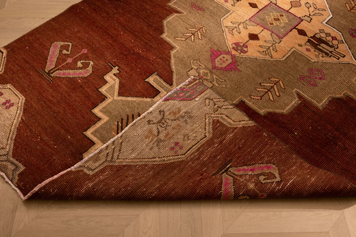Hand-woven 5x9 ft vintage Kars Turkish rug in brown wool and cotton with intricate geometric patterns.