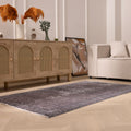 Hand-woven gray overdyed vintage Isparta wool and cotton area rug with floral motifs in a modern living room setting.