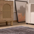 Hand-woven gray overdyed vintage Isparta Turkish wool and cotton area rug with floral motifs on a wooden floor.