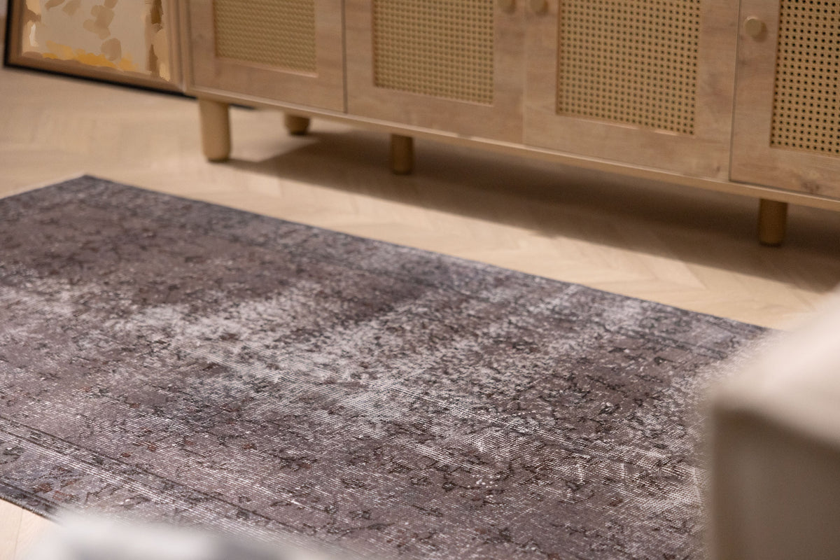 Hand-woven 3x6 ft vintage gray overdyed Turkish Isparta rug with intricate floral patterns and rustic wool-cotton texture.
