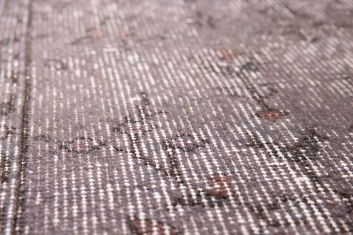 Hand-woven vintage Isparta rug in gray overdyed wool and cotton with rustic floral patterns and low pile texture.
