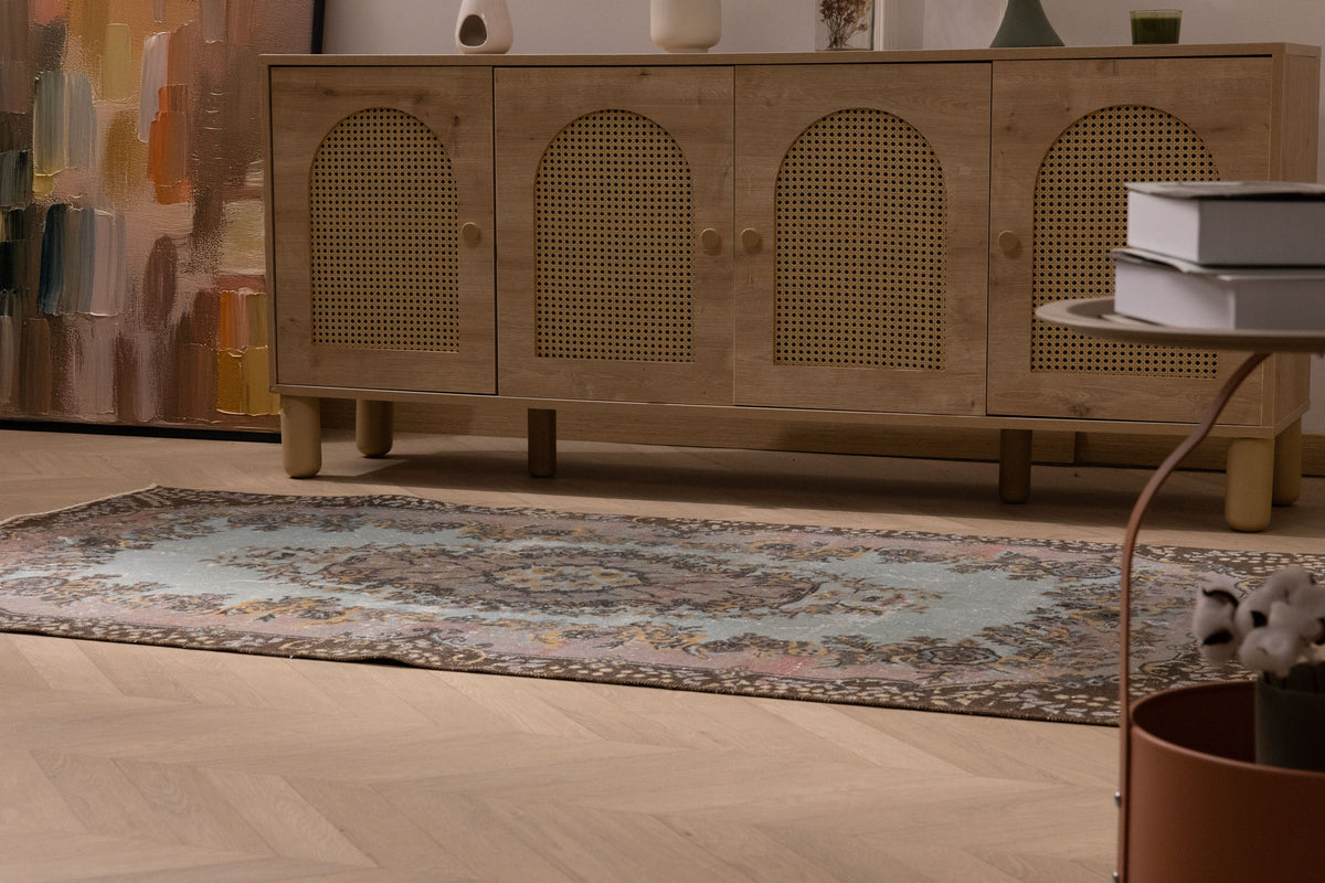 Vintage 3x6 ft Isparta Turkish wool rug with brown and gray floral patterns on a wooden floor.