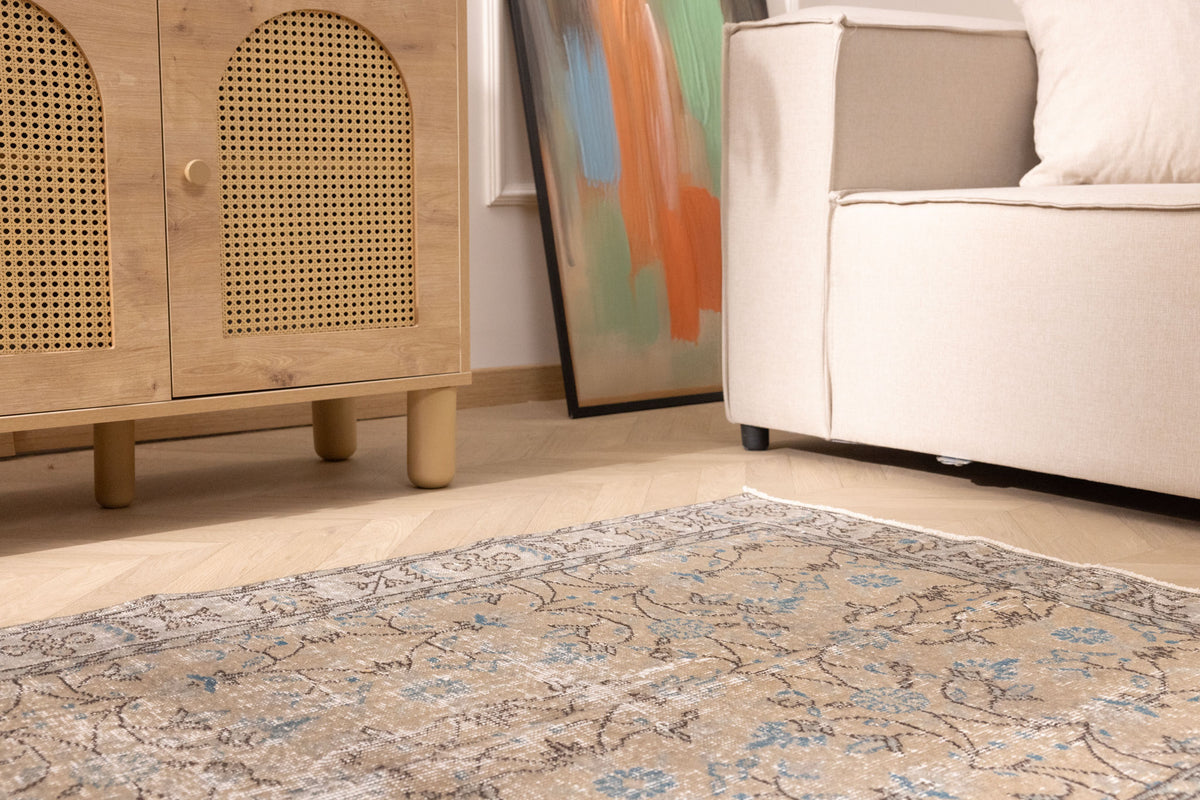 Hand-woven 3x7 ft vintage Isparta Turkish rug with orange floral motifs in a bohemian living room setting.