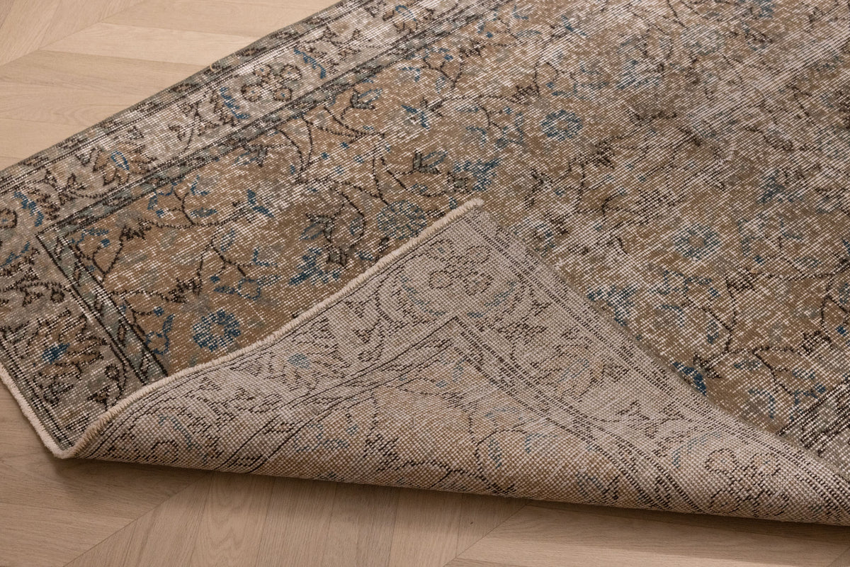 Hand-woven 3x7 ft vintage Isparta rug in burnt orange with floral patterns, crafted from wool and cotton.
