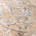 Close-up of a vintage hand-woven Isparta rug featuring orange and blue floral patterns on a wool and cotton blend.