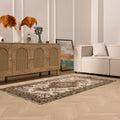Hand-woven 3x6 ft vintage Isparta rug featuring white and sage green floral patterns in a bohemian maximalist style.