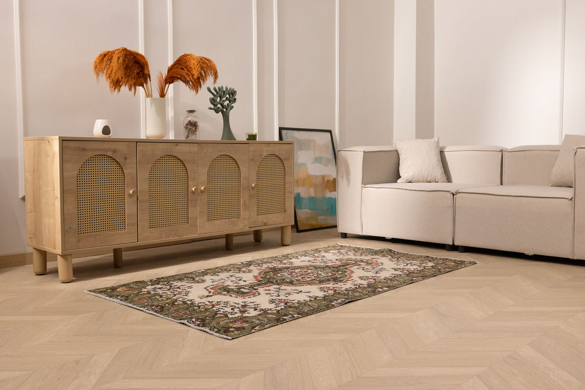Hand-woven 3x6 ft vintage Isparta rug featuring white and sage green floral patterns in a bohemian maximalist style.