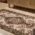 Hand-woven vintage Isparta rug in white and sage green with intricate floral patterns and maximalist bohemian style.