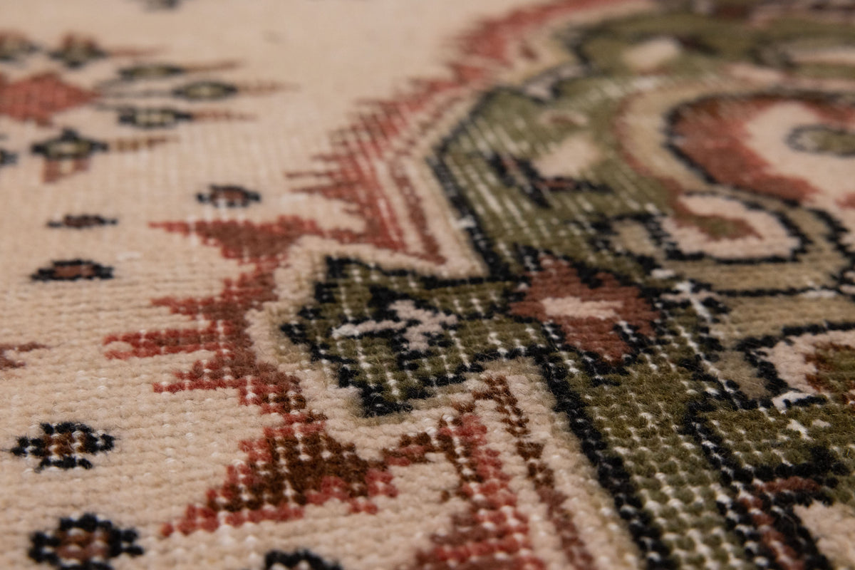 Hand-woven vintage Isparta rug in white and sage green with intricate floral patterns and a soft wool-cotton blend texture.