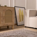 Vintage gray overdyed Isparta Turkish wool and cotton rug with floral patterns in a modern living room setting.