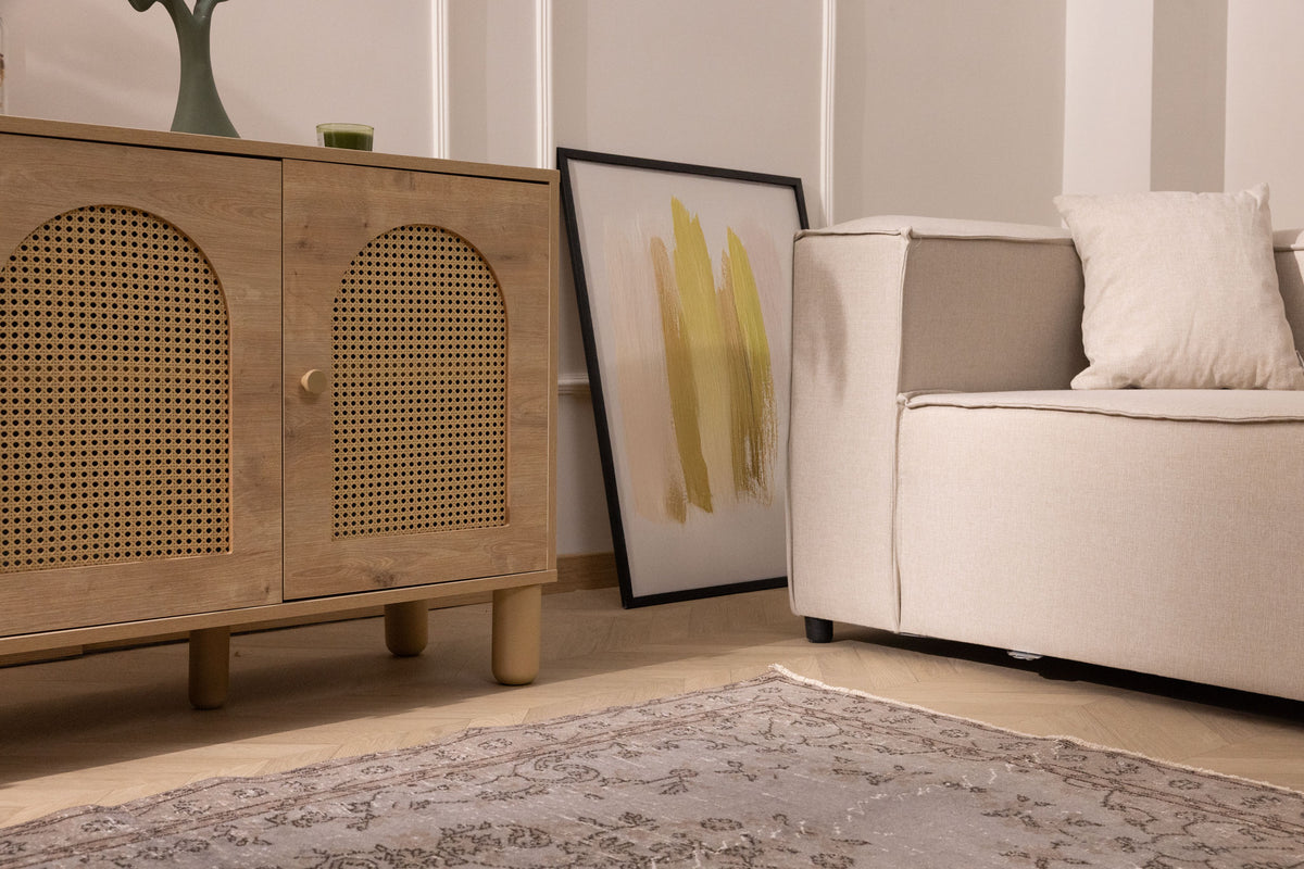 Vintage gray overdyed Isparta Turkish wool and cotton rug with floral patterns in a modern living room setting.