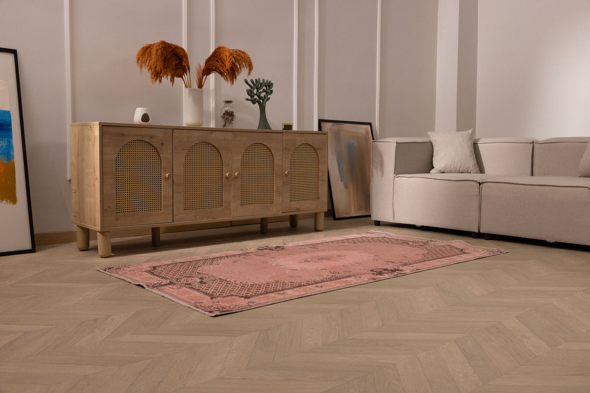 Vintage pink overdyed Turkish area rug with floral patterns, hand-woven in wool and cotton, 3x6 ft size.