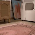 Vintage pink overdyed Turkish area rug with floral patterns, hand-woven from wool and cotton in a 3x6 ft size.