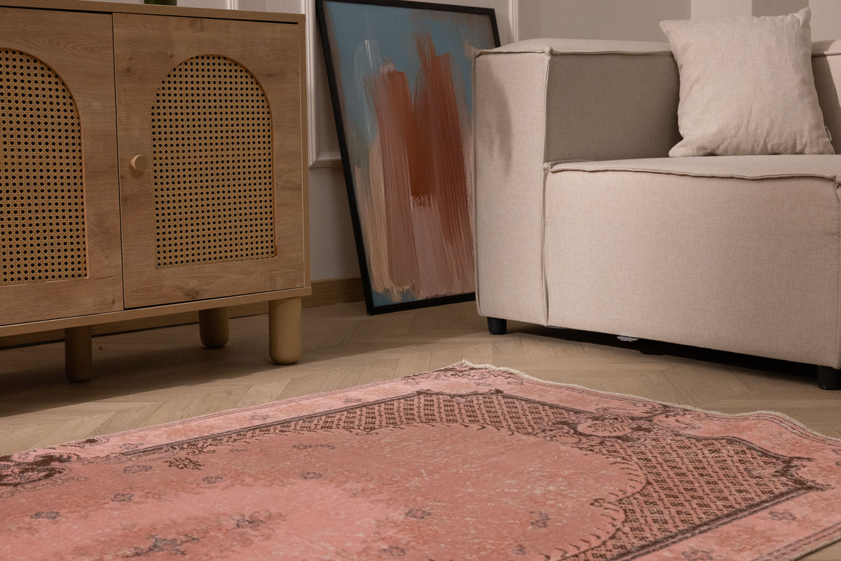 Vintage pink overdyed Turkish area rug with floral patterns, hand-woven from wool and cotton in a 3x6 ft size.