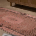 Vintage pink overdyed Turkish Isparta wool rug with floral patterns and a bohemian style, 3x6 ft.